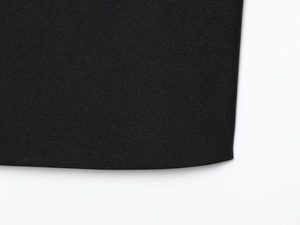 Detailed close-up of high-quality black twill fabric texture with elegant drape