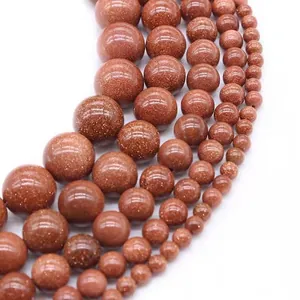 Macro view of polished reddish-brown goldstone beads in various sizes for DIY jewelry