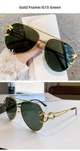 Detail of gold pilot sunglasses with leopard head emblem and G15 green lenses