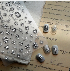 Detail of silver embossed nail stickers with vintage gothic heart and star motifs