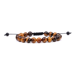 Close-up of natural tiger eye stone beads on a black woven cord with adjustable knot