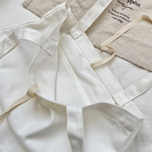 Detailed close-up showing the durable stitching and canvas texture of white tote bag