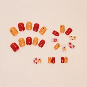 Close-up of fruit press-on nails with 3D cherry accents and star patterns
