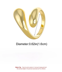 Macro detail of teardrop shaped golden ring made of polished copper with S925 engraving