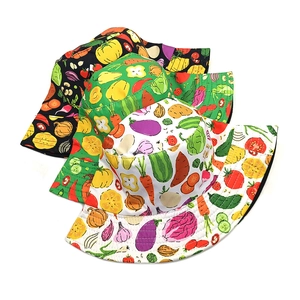 Flat top bucket hat with colorful vegetable print in white, green and black cotton canvas