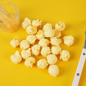 Detailed view of artificial spherical popcorn props with realistic texture on yellow background