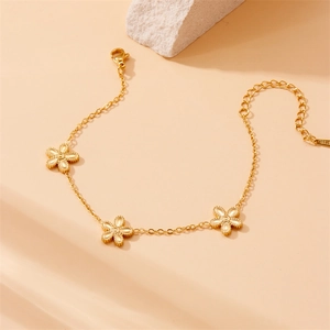 Gold-plated stainless steel bracelet featuring three delicate five-petal flower charms