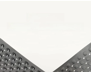 Close-up of non-slip bathroom mat with drainage holes and strong suction cups