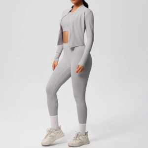 Detail of light gray three-piece yoga set with zip-up jacket and high-waist leggings