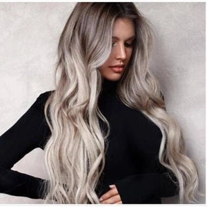 Long wavy ombre wig for women featuring dark roots fading into light blonde curls