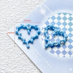 Detail shot of blue heart DIY jewelry pendant with pearl accent, 25mm size overview