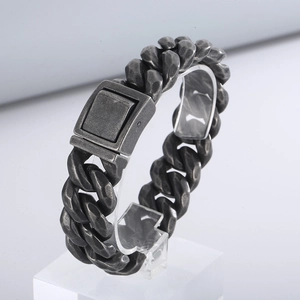 Close-up of vintage oxidized stainless steel Cuban chain bracelet with rectangle clasp
