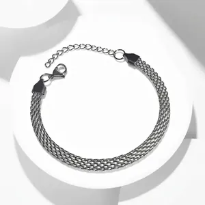 Flat silver woven mesh stainless steel bracelet with lobster clasp on white pedestal