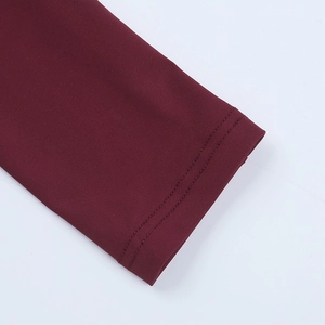 Detailed close-up of wine red sleeve cuff with precise double-needle stitching quality