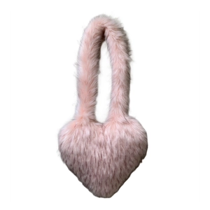 Detailed view of pink heart-shaped faux fur handbag with fluffy and soft plush texture