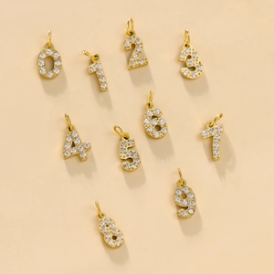 Detailed view of gold plated 0-9 number pendants with full cubic zirconia inlay