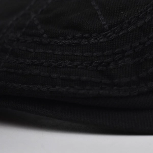 Close-up of precise parallel stitching on breathable black cotton newsboy cap fabric