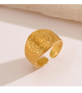 Macro detail of religious St. Benedict medal relief on gold stainless steel wide band ring