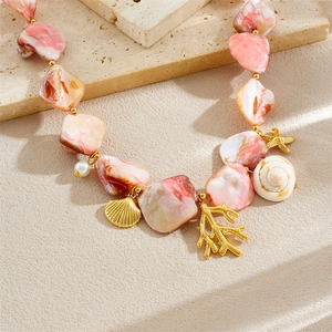 Ocean style gold plated necklace with coral starfish pendants and pink stone beads