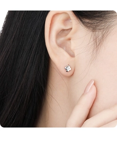 Close-up of minimalist S925 sterling silver four-leaf clover stud earring on ear