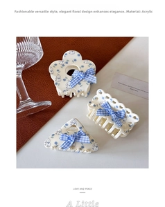 Detailed macro view of three floral hair clips with blue gingham bows and bunny patterns