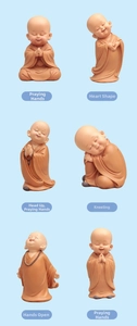 Detailed view of six cute monk figurines in various poses on light blue background