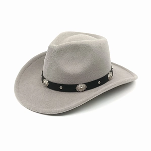 Detail of silver metal floral buckles and rivets on a gray wool western cowboy hat