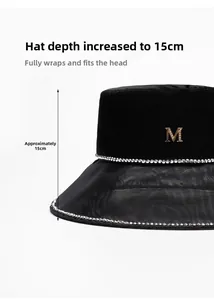 Detail view showing the 15cm deep crown and rhinestone M logo on the black sun hat