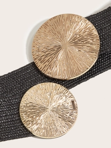 Close-up of woven black elastic belt with dual oversized gold round metal buckles