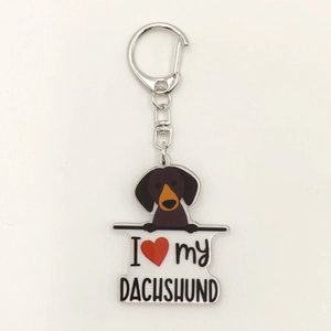 Detail of acrylic keychain featuring dachshund dog illustration and silver metal ring clasp