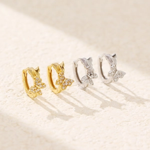 Detailed view of S925 silver butterfly huggie earrings in gold and silver finishes