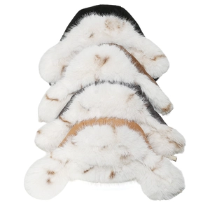 Detailed view of four faux fox fur trims with brown leopard spots on soft white plush