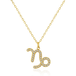 Macro shot of gold-plated Capricorn zodiac pendant necklace with sparkling white zircons