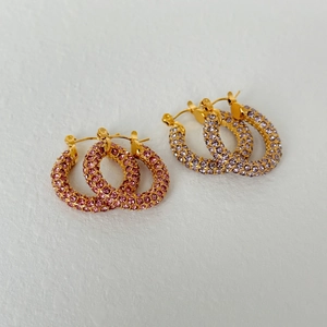 Chic gold-plated hoop earrings featuring vibrant pink and purple pavé cubic zirconia