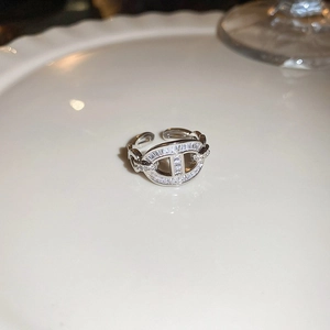 Macro view of silver H-shaped ring with pavé-set rectangular and round zircons