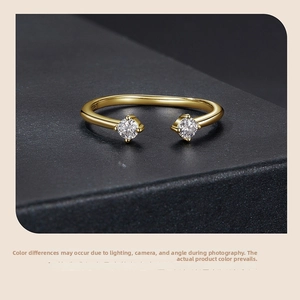 Detail of S925 sterling silver open ring with gold plating and dual round-cut stones