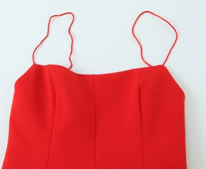 Close-up of red mini dress showing spaghetti straps and premium knit fabric texture