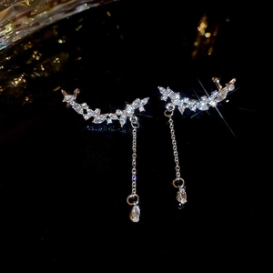Macro shot of silver tassel earrings with marquise and teardrop-shaped zircons