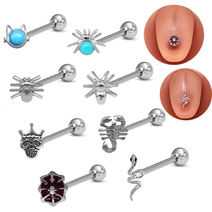 Macro detail of various stainless steel tongue rings with spider and turquoise motifs