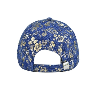 Detail of blue denim baseball cap with gold floral print and silver metal back buckle