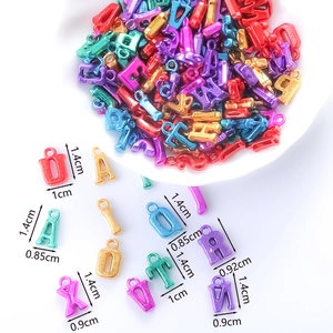 Macro view of macaron colored alphabet beads with clear dimension markings on white background