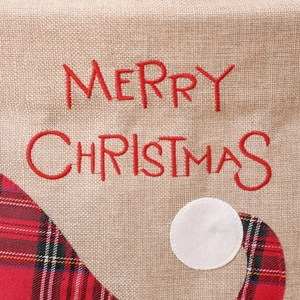 Detailed embroidery of Merry Christmas text on rustic linen holiday chair cover decor