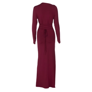 Detail view of deep red slim fit maxi dress featuring crisscross waist tie design