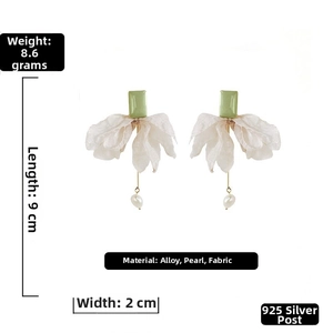 Detail view of 9cm long floral bow earrings with white organza petals and pearl pendants
