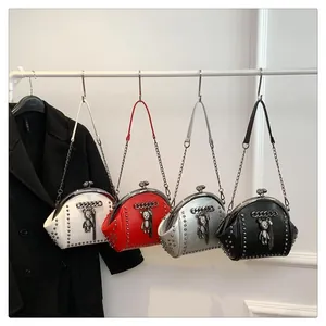 Detail of studded shell handbags in white, red, silver, and black with bear charms