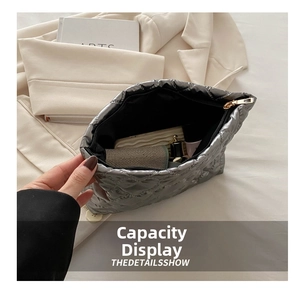 Top view showing the large interior capacity of this silver quilted cosmetic storage bag