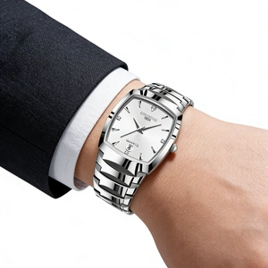 Detail of silver square quartz watch with white dial on wrist with suit