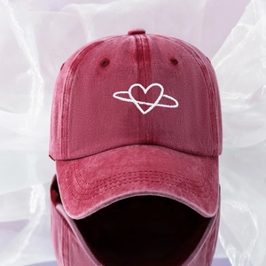Detail of white heart planet embroidery on washed burgundy vintage cotton baseball cap