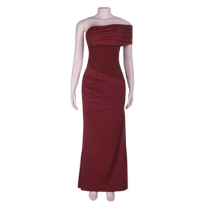 Detail of burgundy off-shoulder evening dress with ruched fabric and glitter waist accent