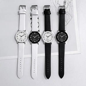 Détails de quatre montres à quartz minimalistes avec bracelets en cuir noir et blanc